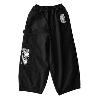 Oversized black Meals pants with white Free & Easy Don't Trip designs on a white background