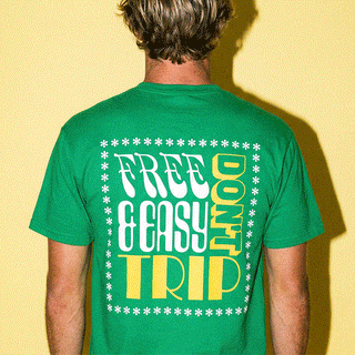 Male and female models in green t-shirt with white and yellow 'Free & Easy Don't Trip' text on a white background