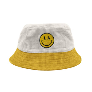 LA Be Happy smiley face embroidered on white corduroy yellow brim bucket hat on white background, front - Free & Easy