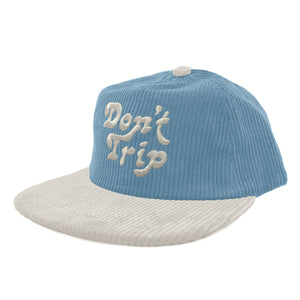 Don't Trip blue and white corduroy hat with white embroidered Don't Trip logo on a white background, front - Free & Easy