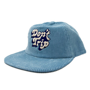 Don't Trip light blue corduroy hat with white and navy embroidered Don't Trip logo on a white background, front - Free & Easy