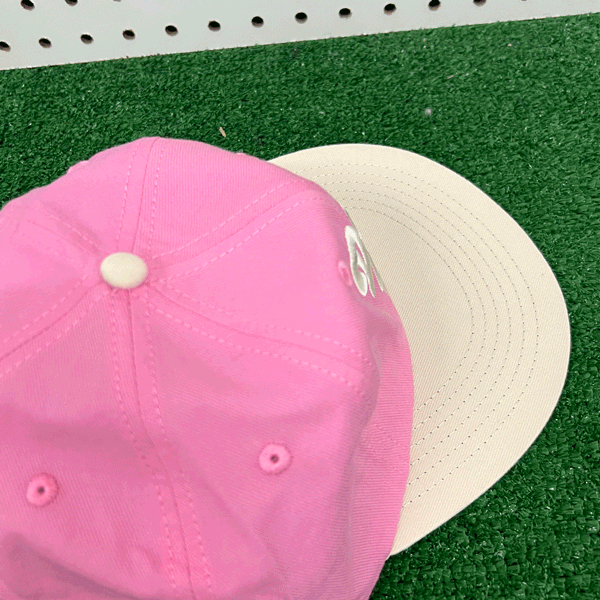 Don't Trip pink hat white brim with white embroidered Don't Trip logo on grass background - Free & Easy