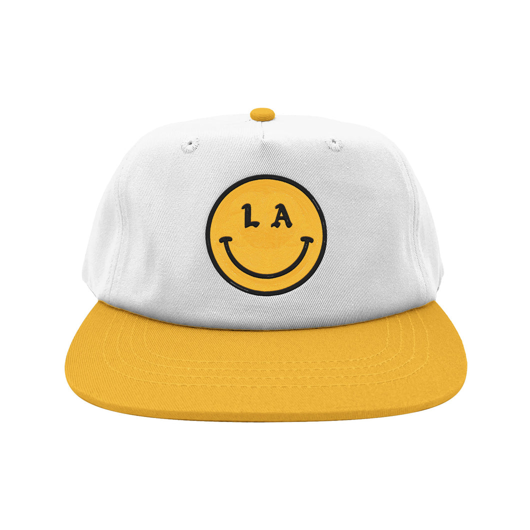 Be Happy LA white hat yellow brim with yellow and black smiley face embroidery on white background, front - Free & Easy