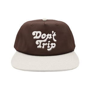 Don't Trip brown hat white brim with white embroidered Don't Trip logo on white background, front - Free & Easy