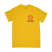 Load image into Gallery viewer, Island Flower Short Sleeve Tee in yellow with an oraange flower and brown Free &amp; Easy Don&#39;t Trip on a white background - Free &amp; Easy
