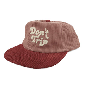 Don't Trip pink corduroy red brim hat with white embroidered Don't Trip logo on a white background - Free & Easy
