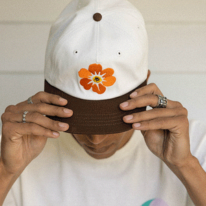 Free & Easy white and brown hat with orange and yellow flower on models - Free & Easy