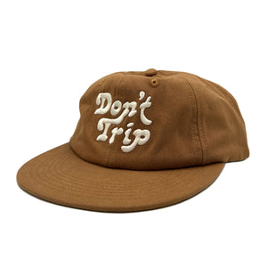 Don't Trip light brown hat with white embroidered Don't Trip logo on white background, front - Free & Easy