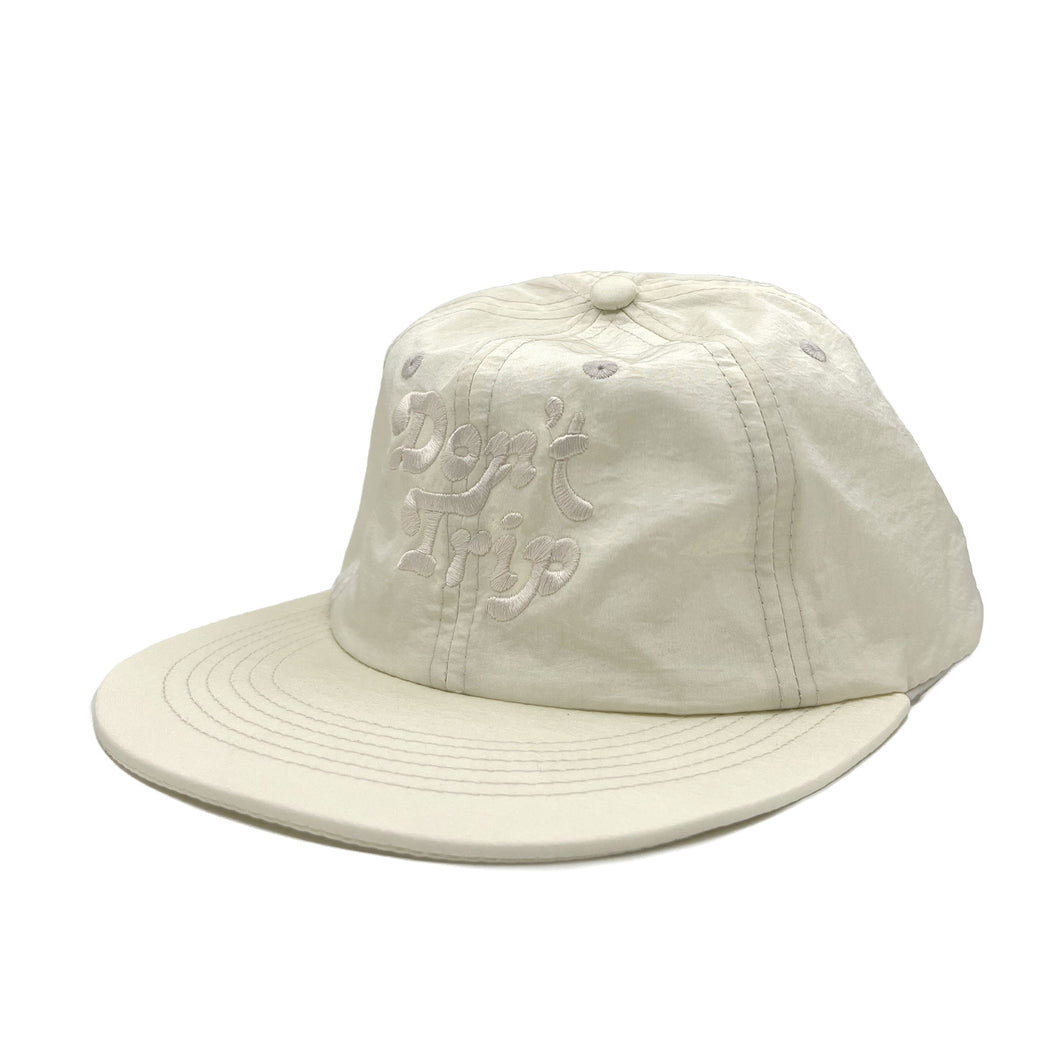 Don't Trip Clipback Crinkle Hat in bone with white Don't Trip embroidery on a white background - Free & Easy