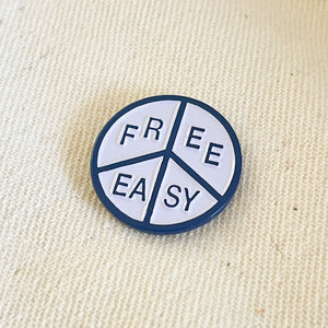 Free & Easy Peace Enamel Pin in navy and white on a natural background - Free & Easy