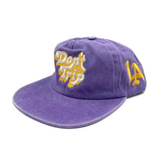 Don't Trip Washed Snapback Hat in purple with white and yellow Don't Trip embroidery and a yellow LA design on a white background -Free & Easy