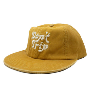 Don't Trip yellow hat with white embroidered Don't Trip logo on white background, front - Free & Easy